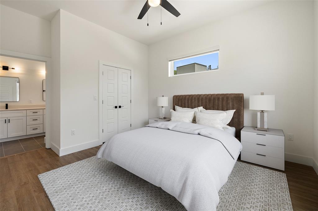 1811 Webberville Road, Unit 1305 Austin, TX 78721 - Photo 11 of 15 a bedroom with a bed and a chandelier