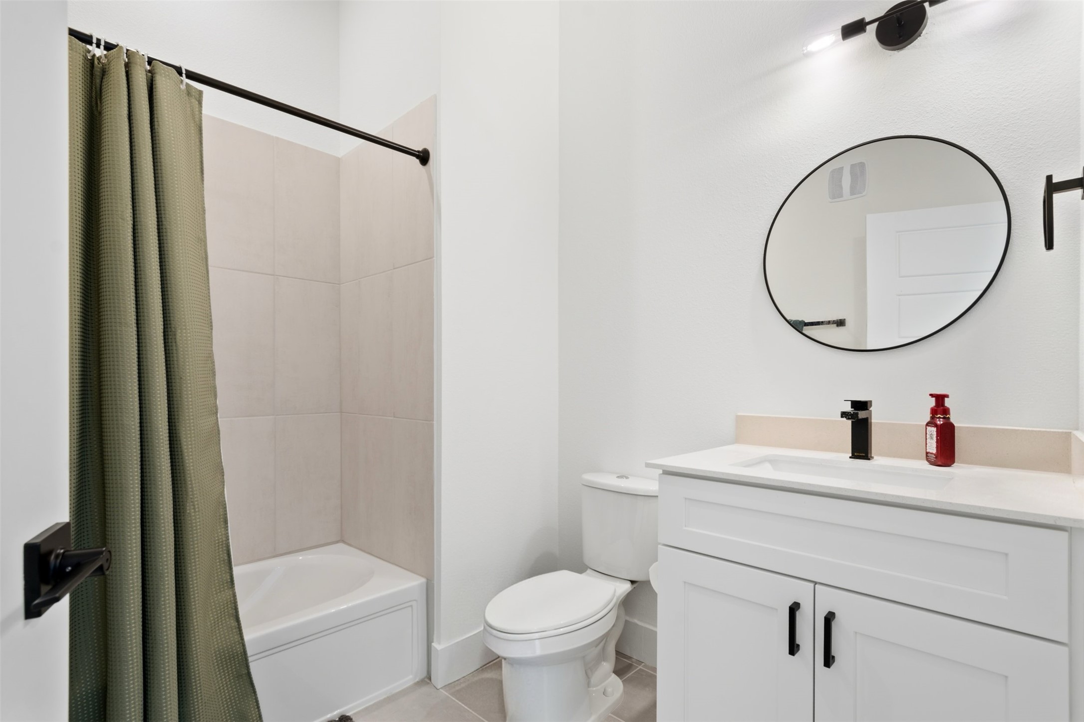 1811 Webberville Road, Unit 1305 Austin, TX 78721 - Photo 12 of 15 a bathroom with a toilet sink vanity and mirror