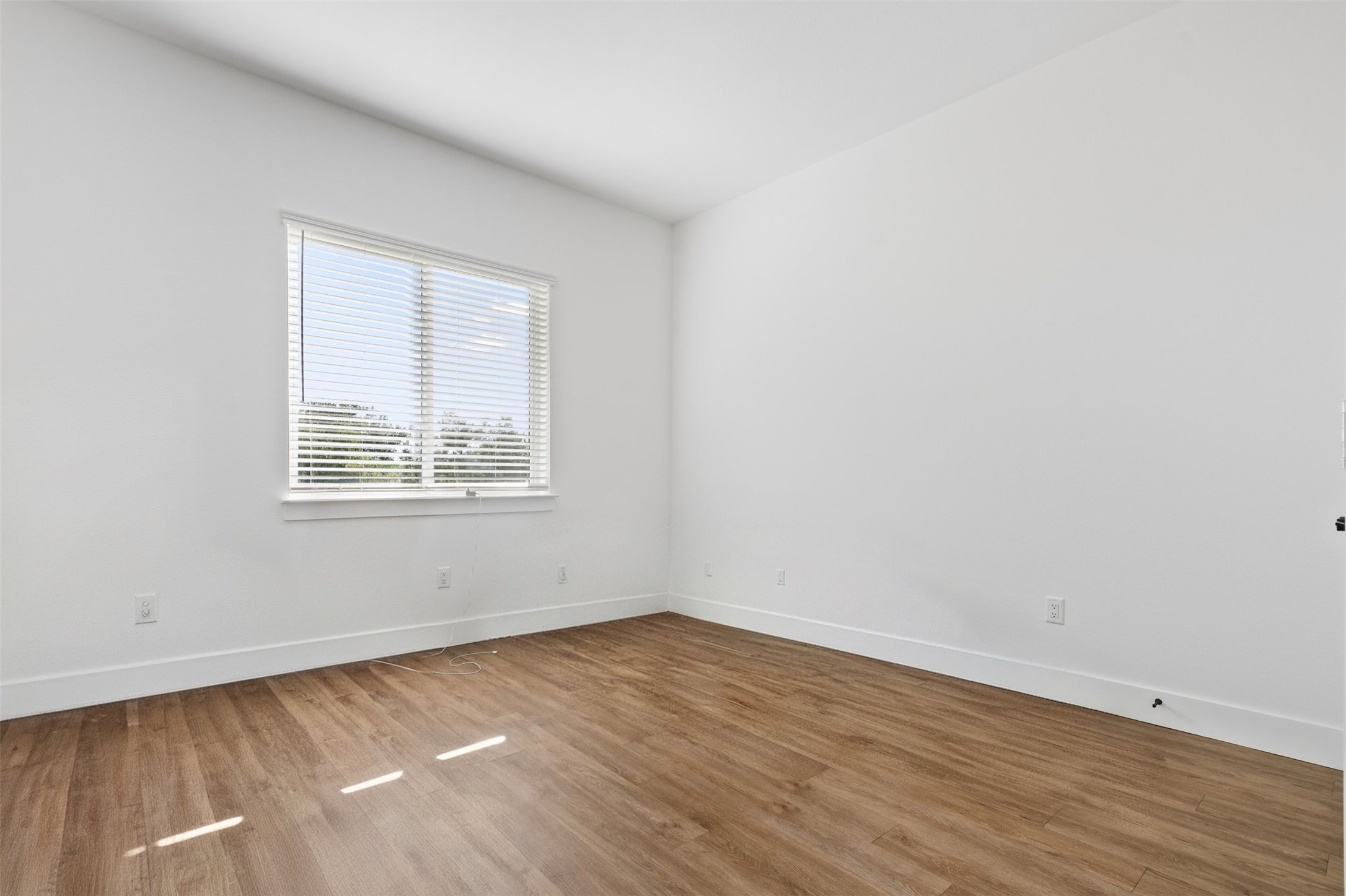 1811 Webberville Road, Unit 1305 Austin, TX 78721 - Photo 15 of 15 an empty room with wooden floor and windows
