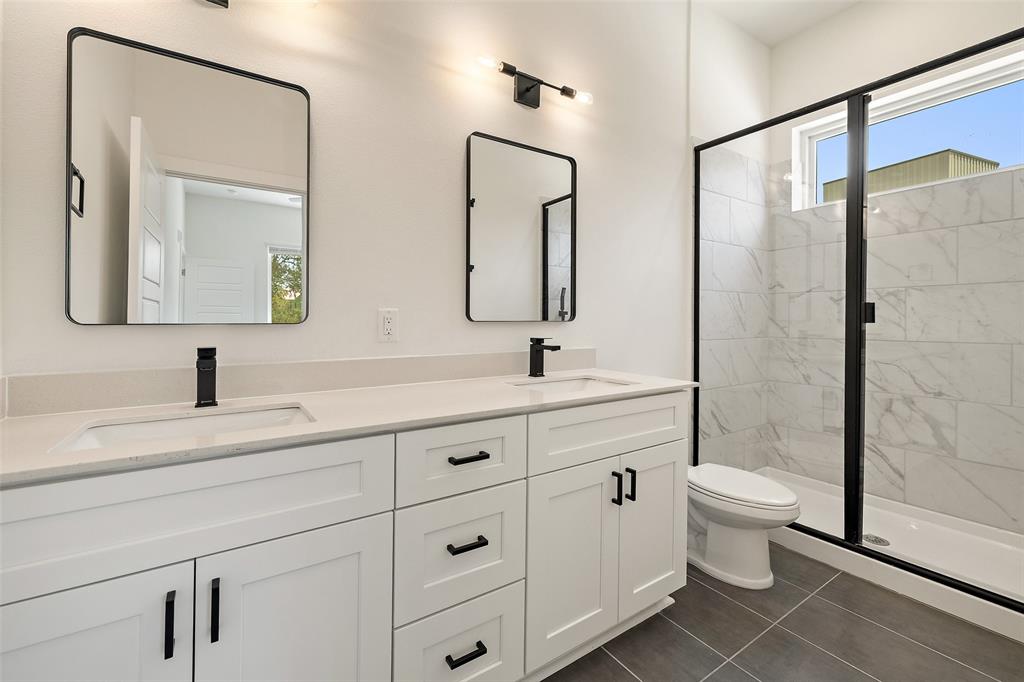 1811 Webberville Road, Unit 1305 Austin, TX 78721 - Photo 10 of 15 a bathroom with a double vanity sink mirror and toilet
