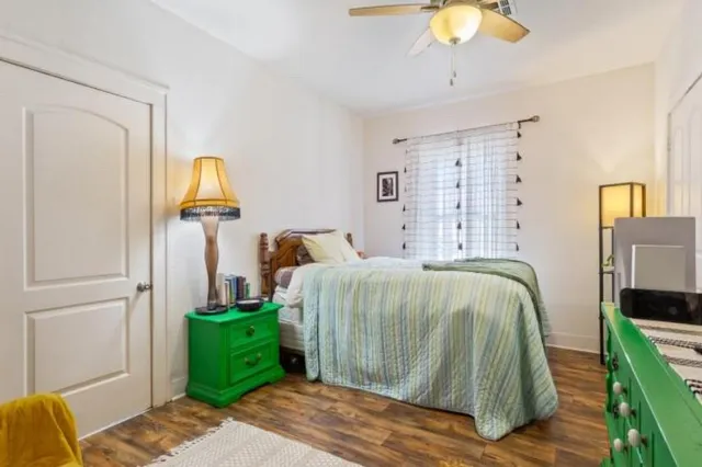 a bedroom with a bed and a chandelier