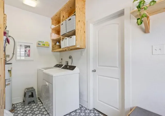 a utility room with a sink a washer and dryer