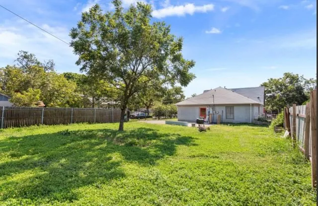 a house with a big yard and large trees