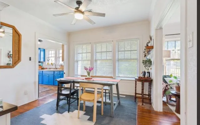 a view of a dining room with furniture and wooden floor