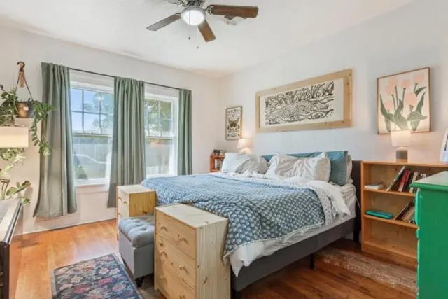 a bedroom with a large bed and a chandelier