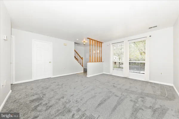 a view of an empty room and a window