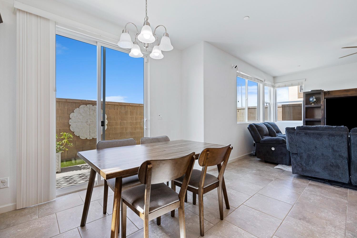 3606 Parkstone Way Clovis, CA 93619 - Photo 12 of 38 a view of a dining room with furniture and wooden floor