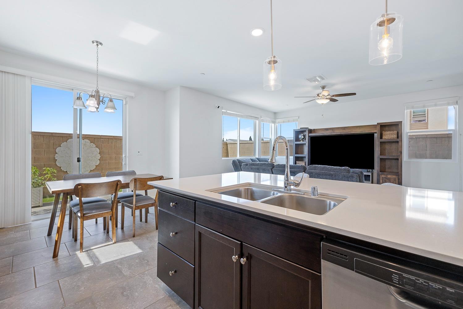 3606 Parkstone Way Clovis, CA 93619 - Photo 15 of 38 a kitchen with a sink a counter and chairs