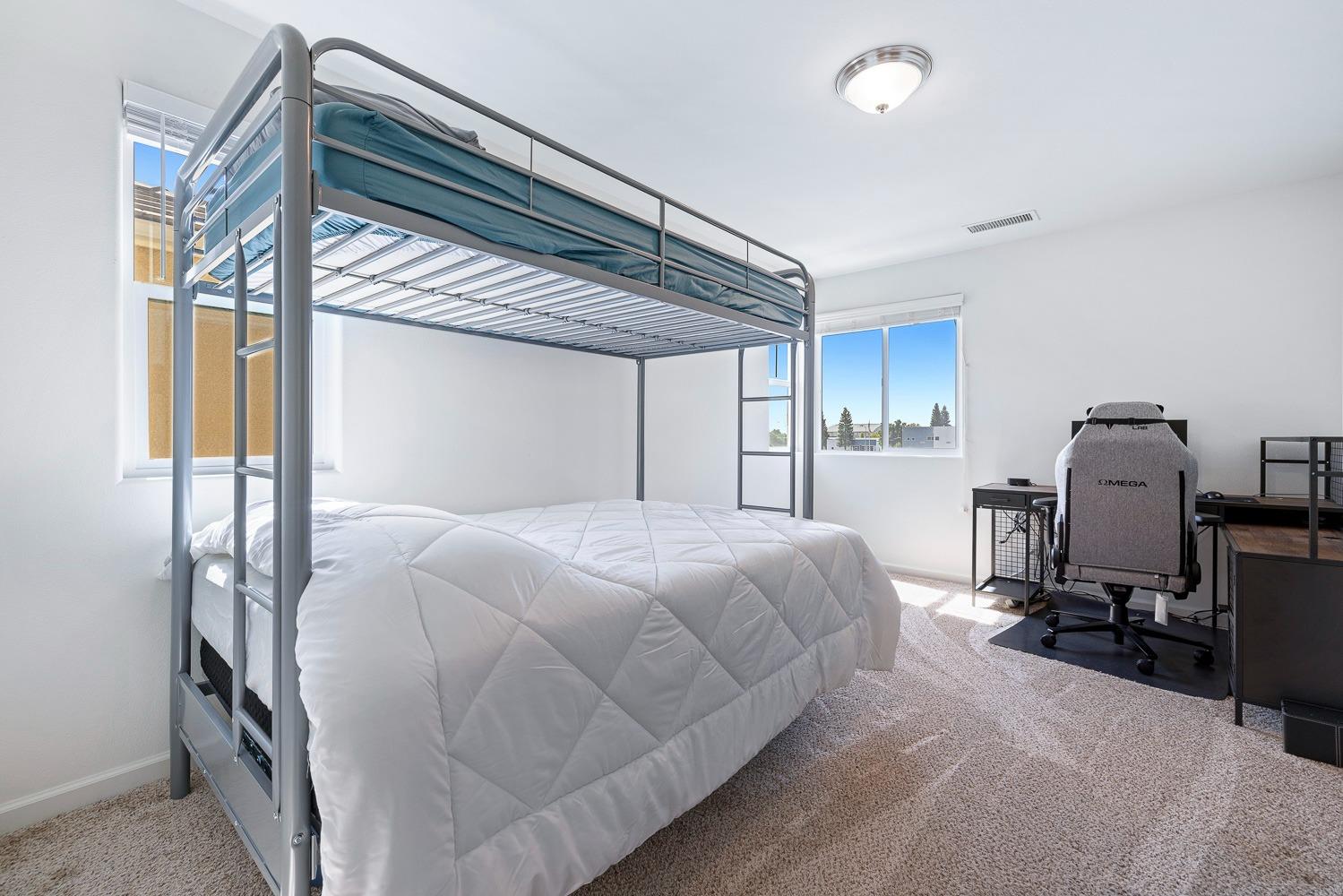 3606 Parkstone Way Clovis, CA 93619 - Photo 17 of 38 a bedroom with a bed a flat screen tv and a window