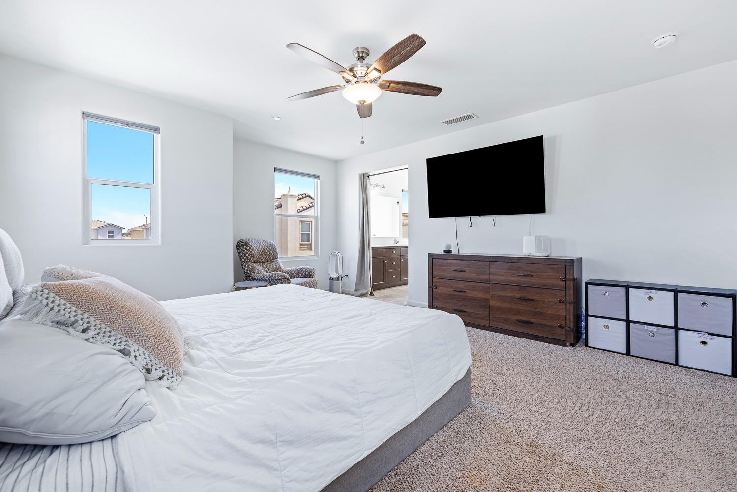 3606 Parkstone Way Clovis, CA 93619 - Photo 21 of 38 a bedroom with a bed and a flat screen tv