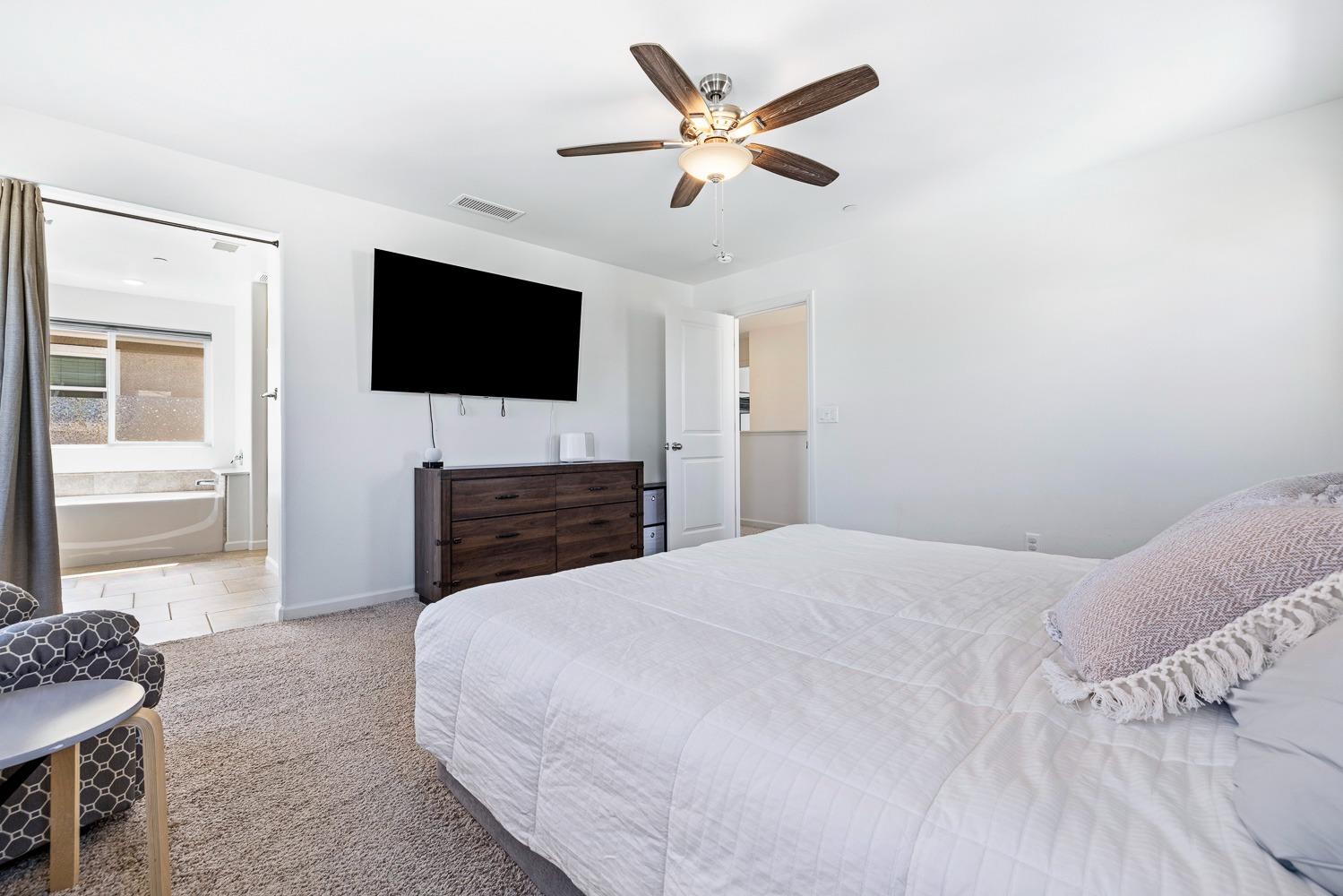3606 Parkstone Way Clovis, CA 93619 - Photo 22 of 38 a bedroom with a bed and a flat screen tv