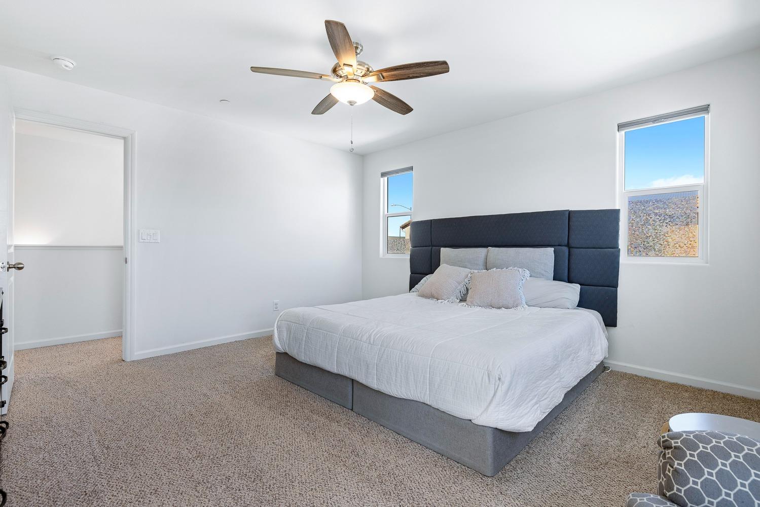 3606 Parkstone Way Clovis, CA 93619 - Photo 23 of 38 a bedroom with a bed and a ceiling fan