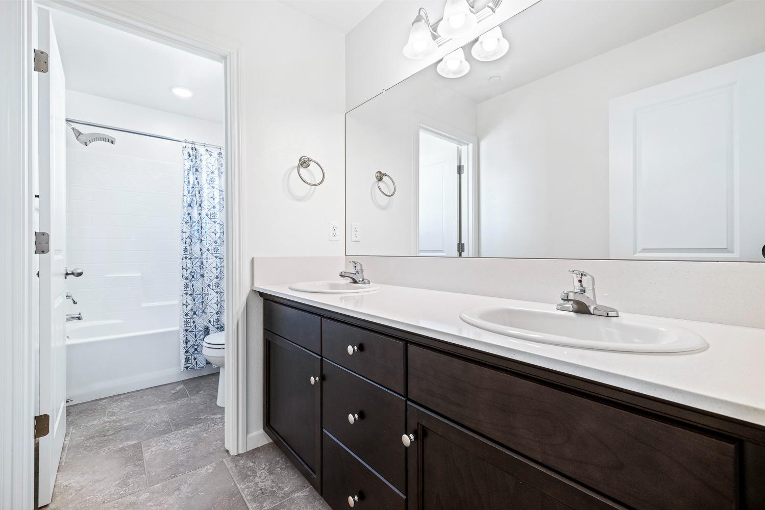3606 Parkstone Way Clovis, CA 93619 - Photo 29 of 38 a bathroom with a sink double vanity granite tub and a mirror