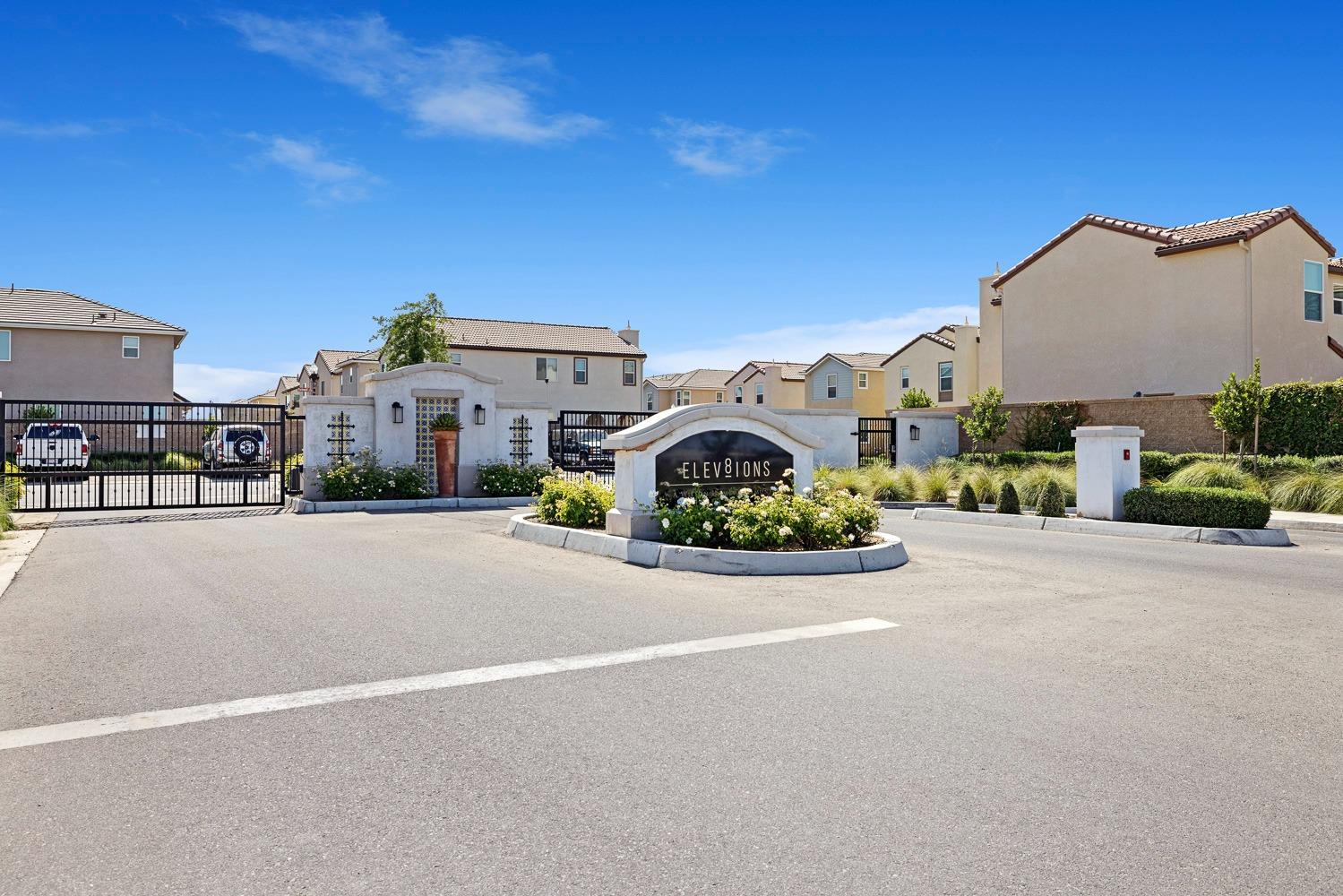 3606 Parkstone Way Clovis, CA 93619 - Photo 36 of 38 a view of a street with a building and couple of cars parked in front of it