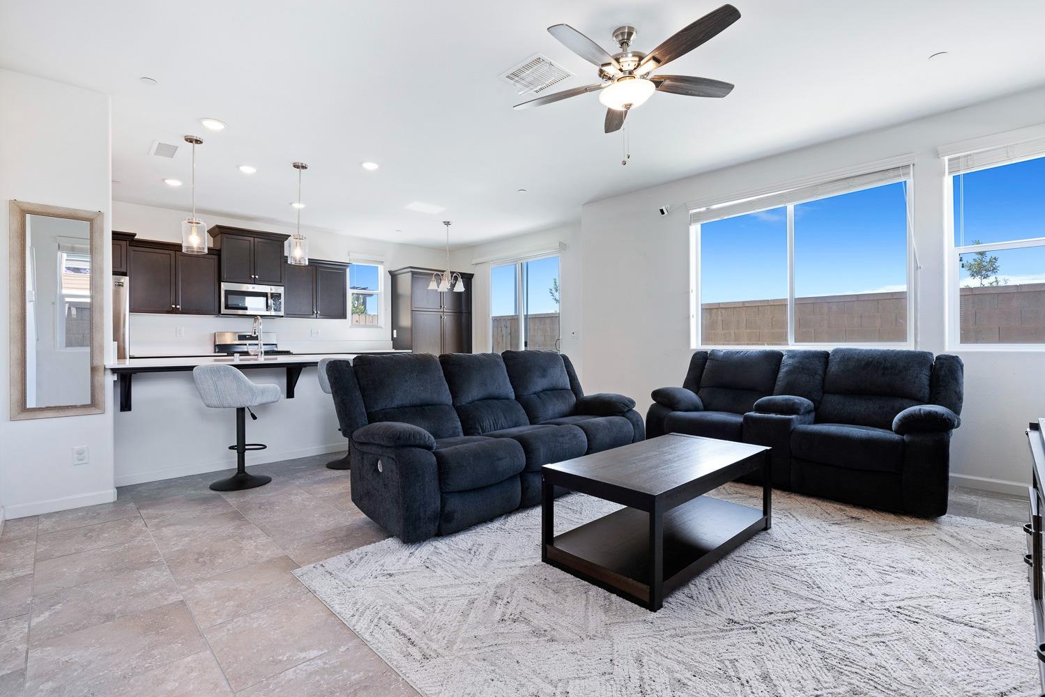 3606 Parkstone Way Clovis, CA 93619 - Photo 6 of 38 a living room with stainless steel appliances kitchen island granite countertop furniture and a view of kitchen