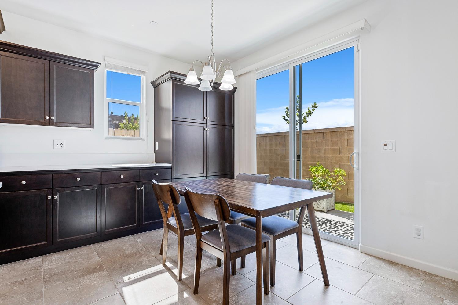 3606 Parkstone Way Clovis, CA 93619 - Photo 8 of 38 a view of a dining room with furniture a chandelier and wooden floor