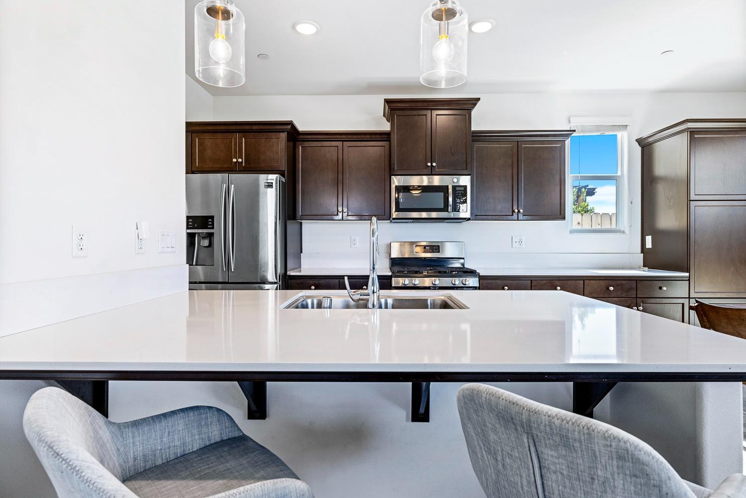 3606 Parkstone Way Clovis, CA 93619 - Photo 10 of 38 a kitchen with stainless steel appliances a sink and a refrigerator