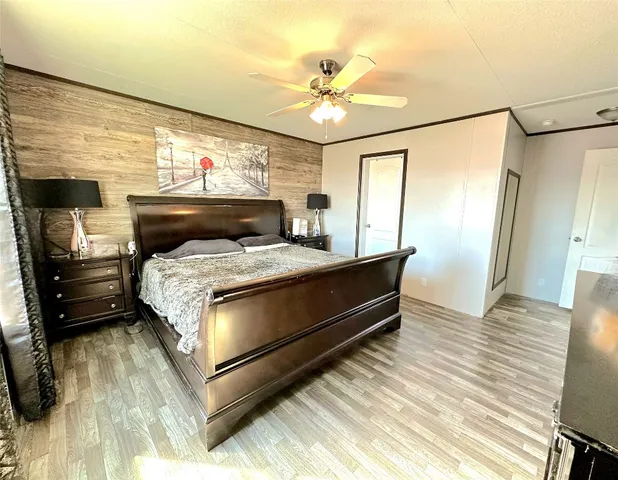 a bedroom with a bed and wooden floor