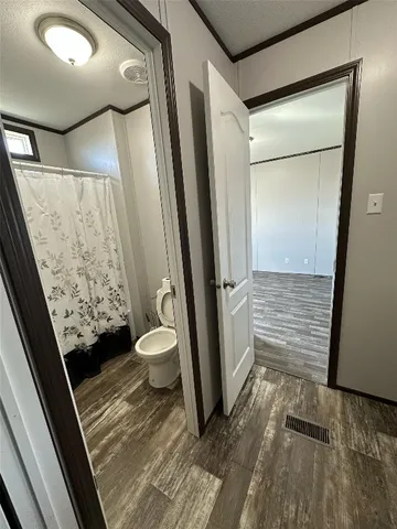 a bathroom with a granite countertop shower and a toilet