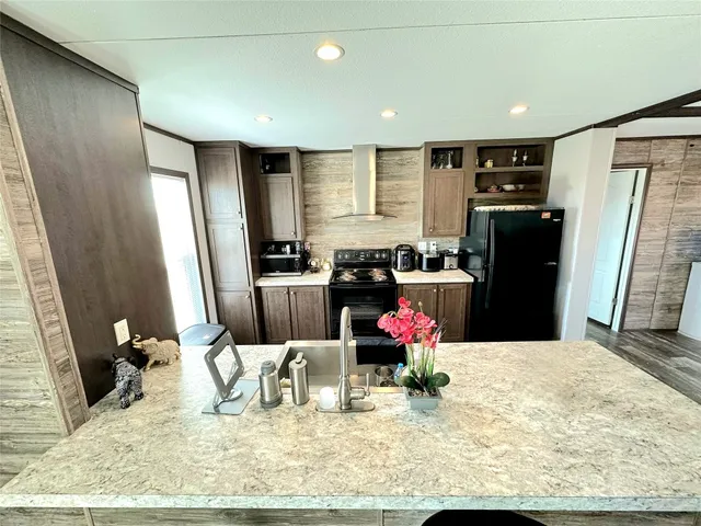 a kitchen with refrigerator and sink