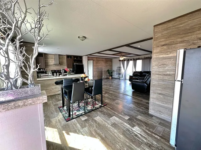 a kitchen with stainless steel appliances kitchen island granite countertop a stove and cabinets