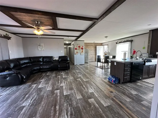 a living room with lots of furniture and a wooden floor