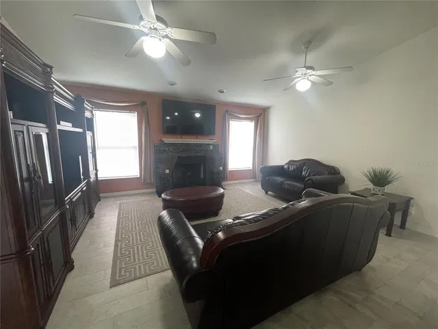 a living room with furniture and a fireplace