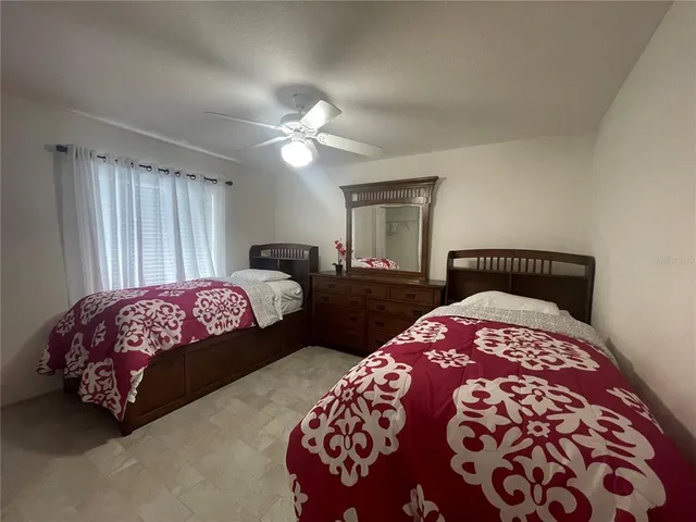 a bedroom with a large bed and a two windows