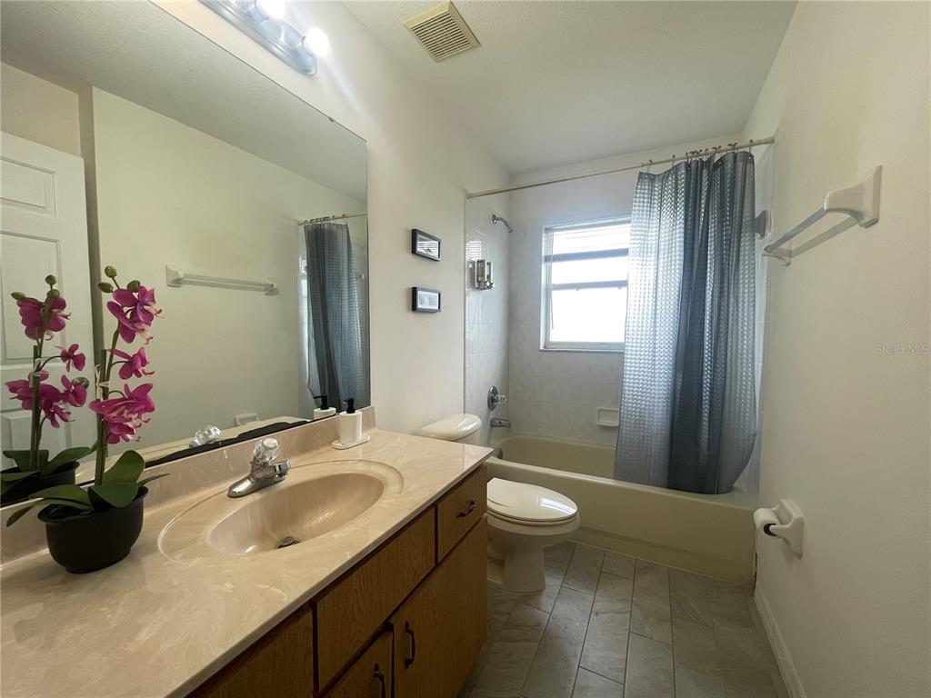 8759 Southwest 52nd Court Ocala, FL 34476 - Photo 16 of 20 a bathroom with a sink a toilet and shower