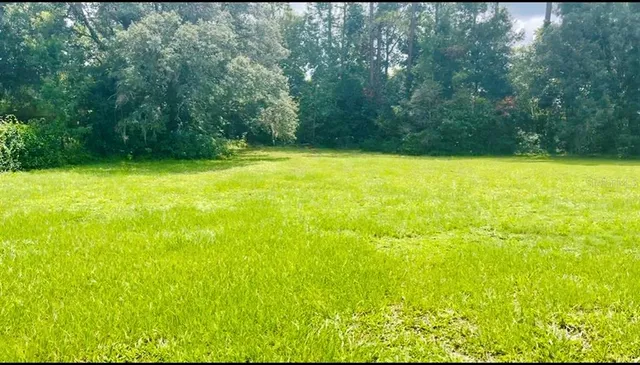 a view of yard with swimming pool and outdoor seating