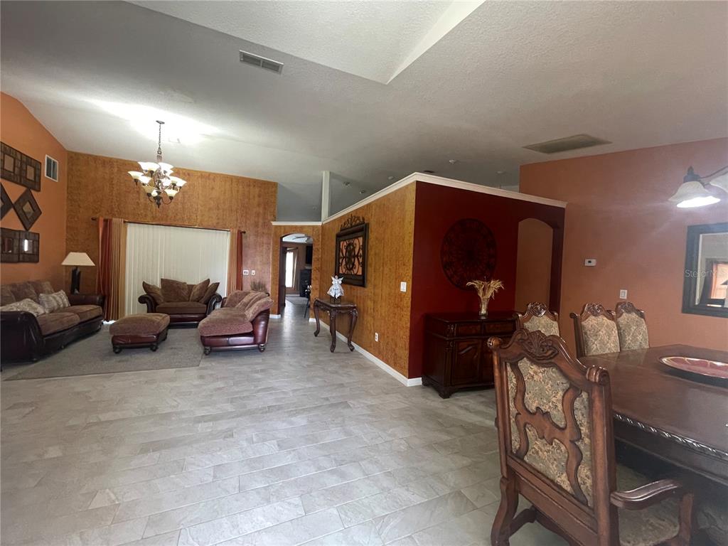 8759 Southwest 52nd Court Ocala, FL 34476 - Photo 2 of 20 a living room with furniture and a lamp