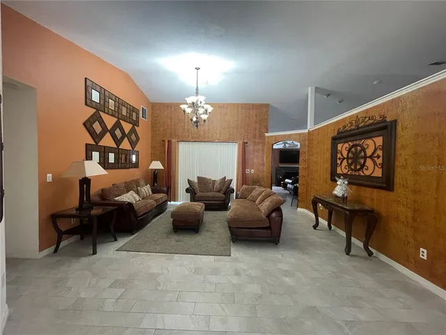 a living room with furniture and a chandelier