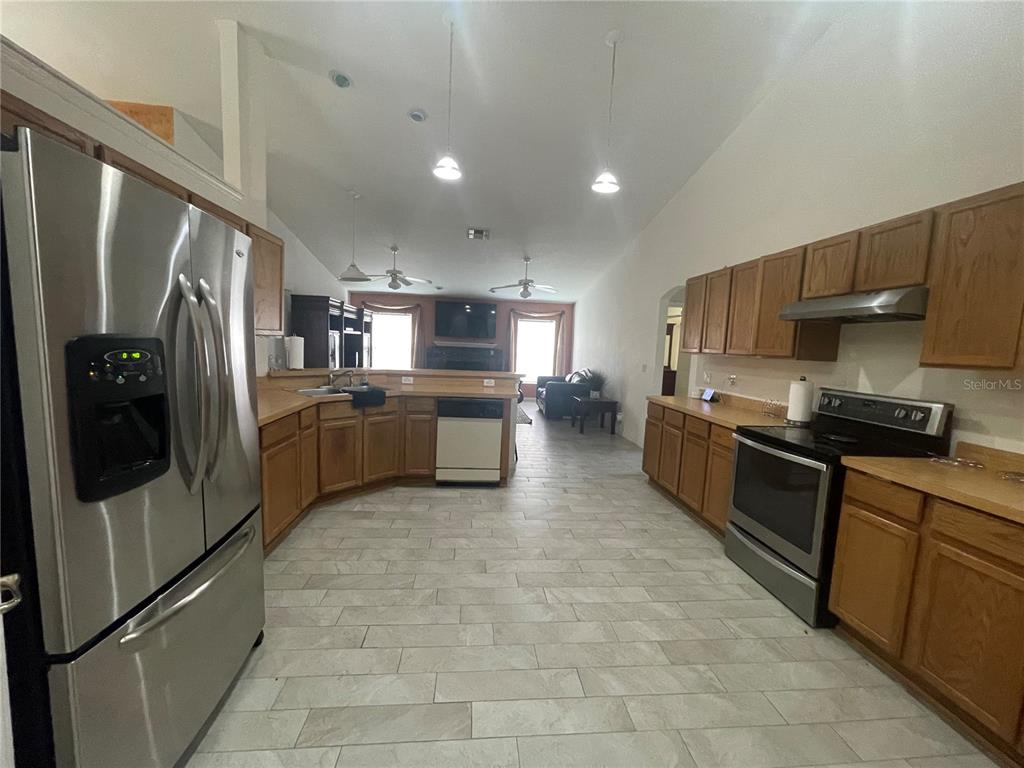 8759 Southwest 52nd Court Ocala, FL 34476 - Photo 5 of 20 a large kitchen with stainless steel appliances lots of counter top space