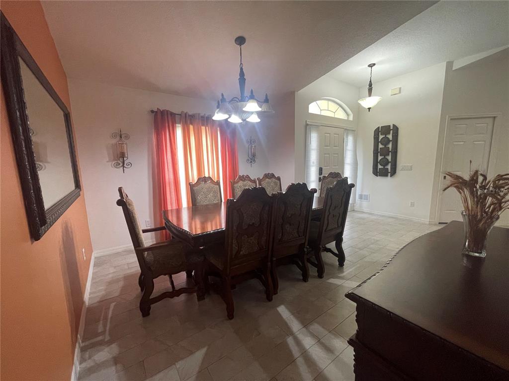8759 Southwest 52nd Court Ocala, FL 34476 - Photo 7 of 20 a view of a dining room with furniture and window