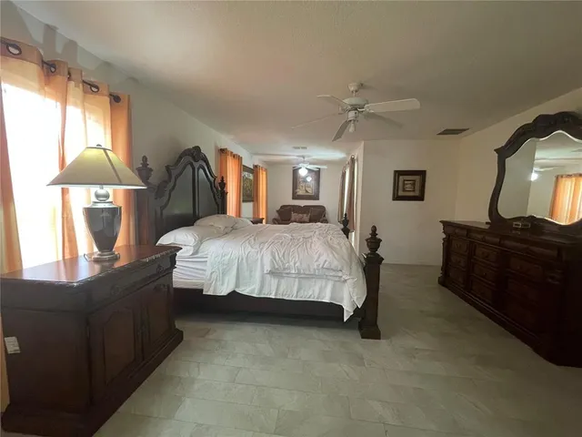 a bedroom with a bed dresser and a window