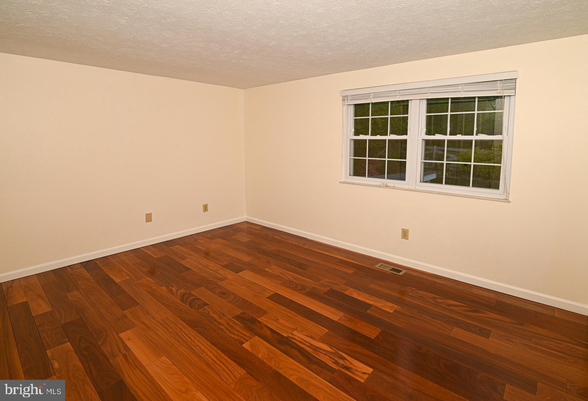 8110 Winter Blue Court Springfield, VA 22153 - Photo 12 of 24 a view of empty room with wooden floor and windows