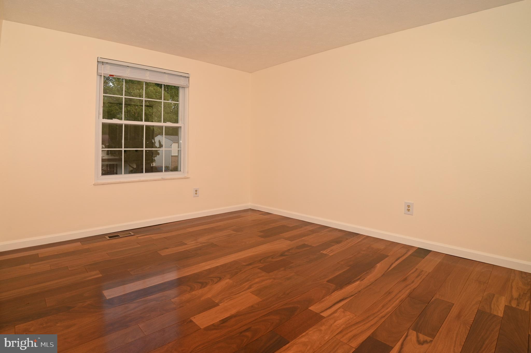 8110 Winter Blue Court Springfield, VA 22153 - Photo 13 of 24 an empty room with wooden floor and windows