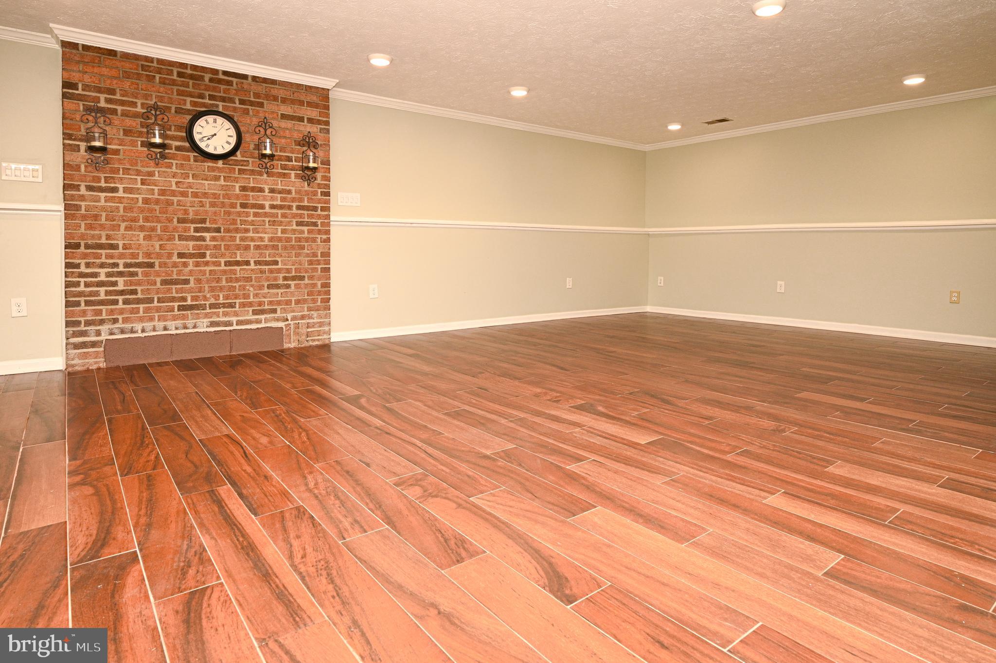 8110 Winter Blue Court Springfield, VA 22153 - Photo 17 of 24 a view of an empty room with wooden floor and a sink