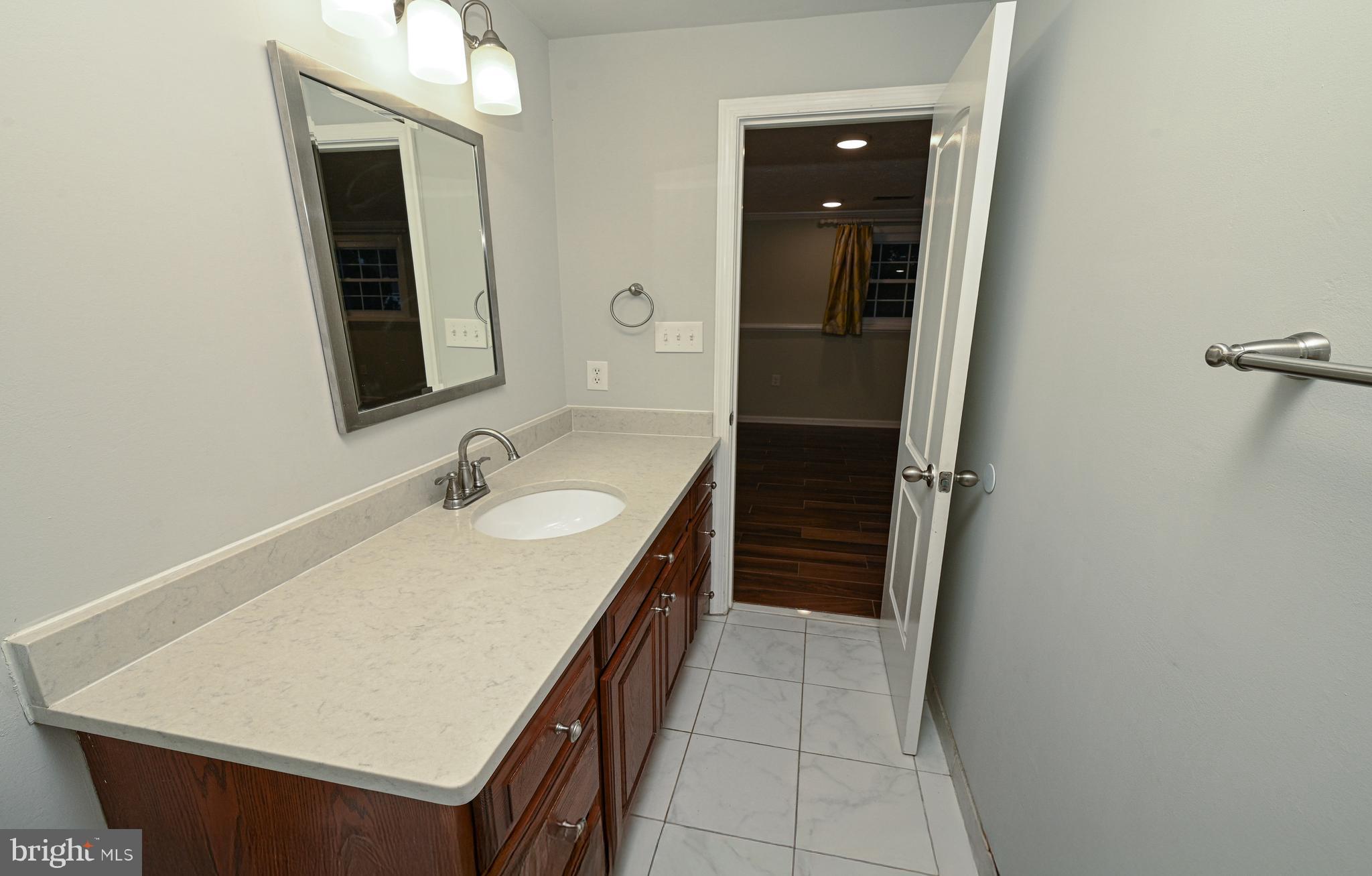 8110 Winter Blue Court Springfield, VA 22153 - Photo 18 of 24 a bathroom with a sink a vanity and mirror