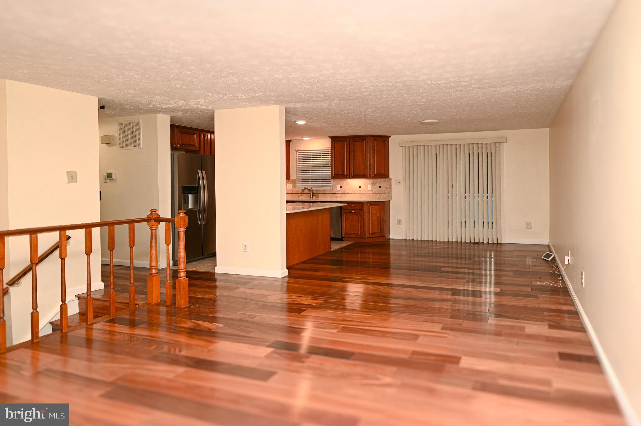 8110 Winter Blue Court Springfield, VA 22153 - Photo 5 of 24 a view of a room with wooden floor and a sink