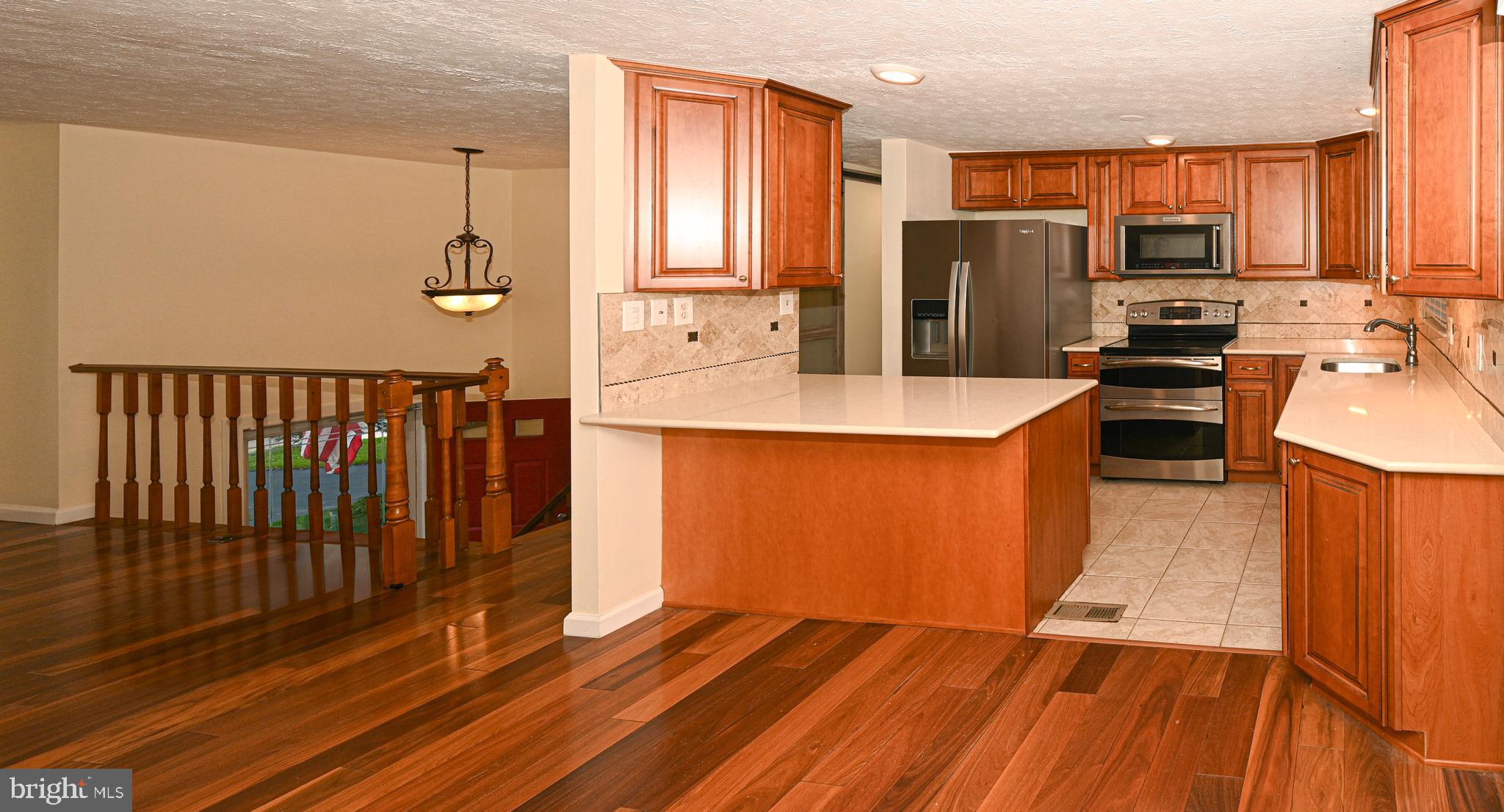 8110 Winter Blue Court Springfield, VA 22153 - Photo 7 of 24 a kitchen with stainless steel appliances a refrigerator and a stove top oven