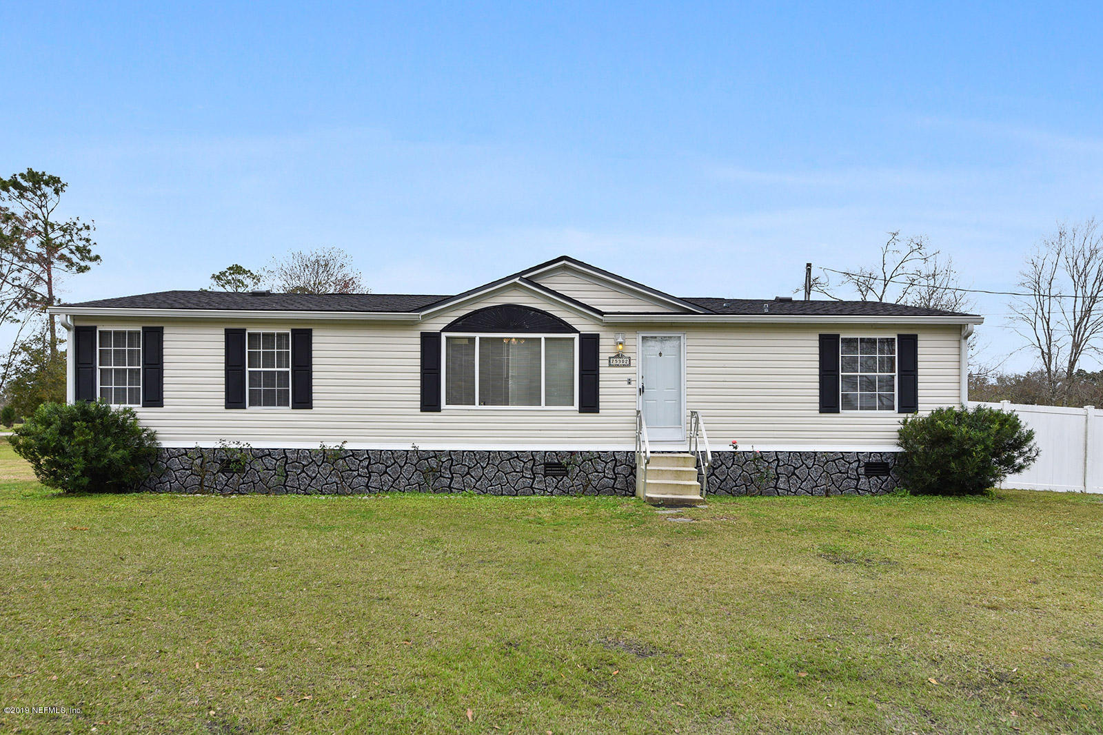 75302 Edwards Road Yulee, FL 32097 - Photo 1 of 25 a front view of a house with a yard