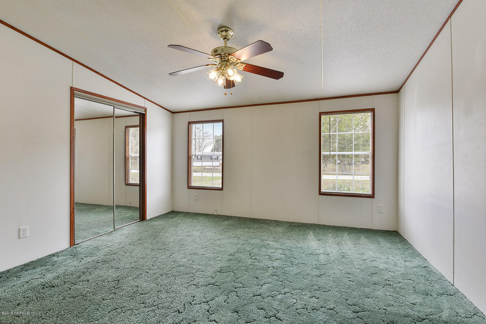75302 Edwards Road Yulee, FL 32097 - Photo 12 of 25 an empty room with windows and fan