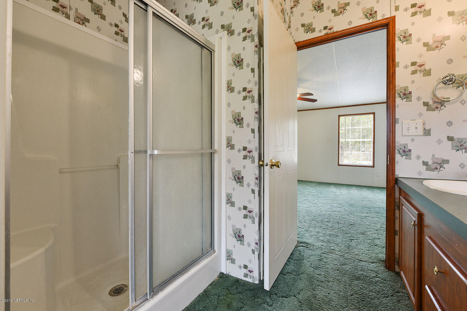 75302 Edwards Road Yulee, FL 32097 - Photo 15 of 25 a view of a bathroom with a granite countertop shower and a sink