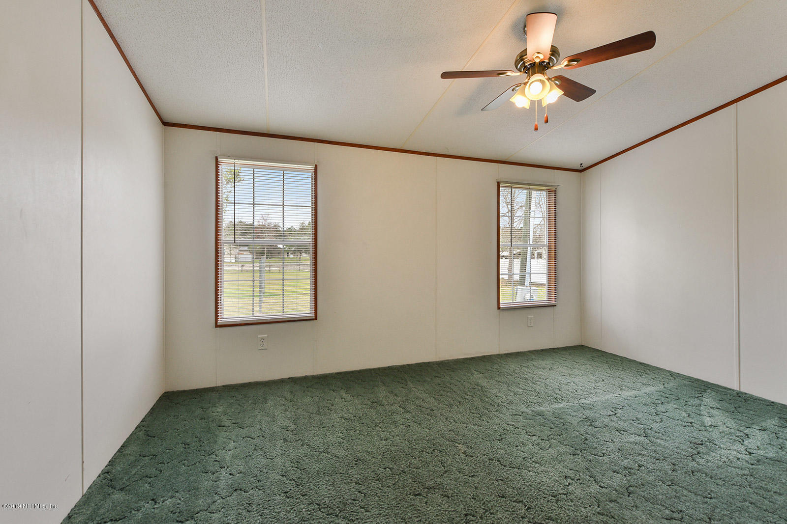 75302 Edwards Road Yulee, FL 32097 - Photo 16 of 25 an empty room with windows and fan