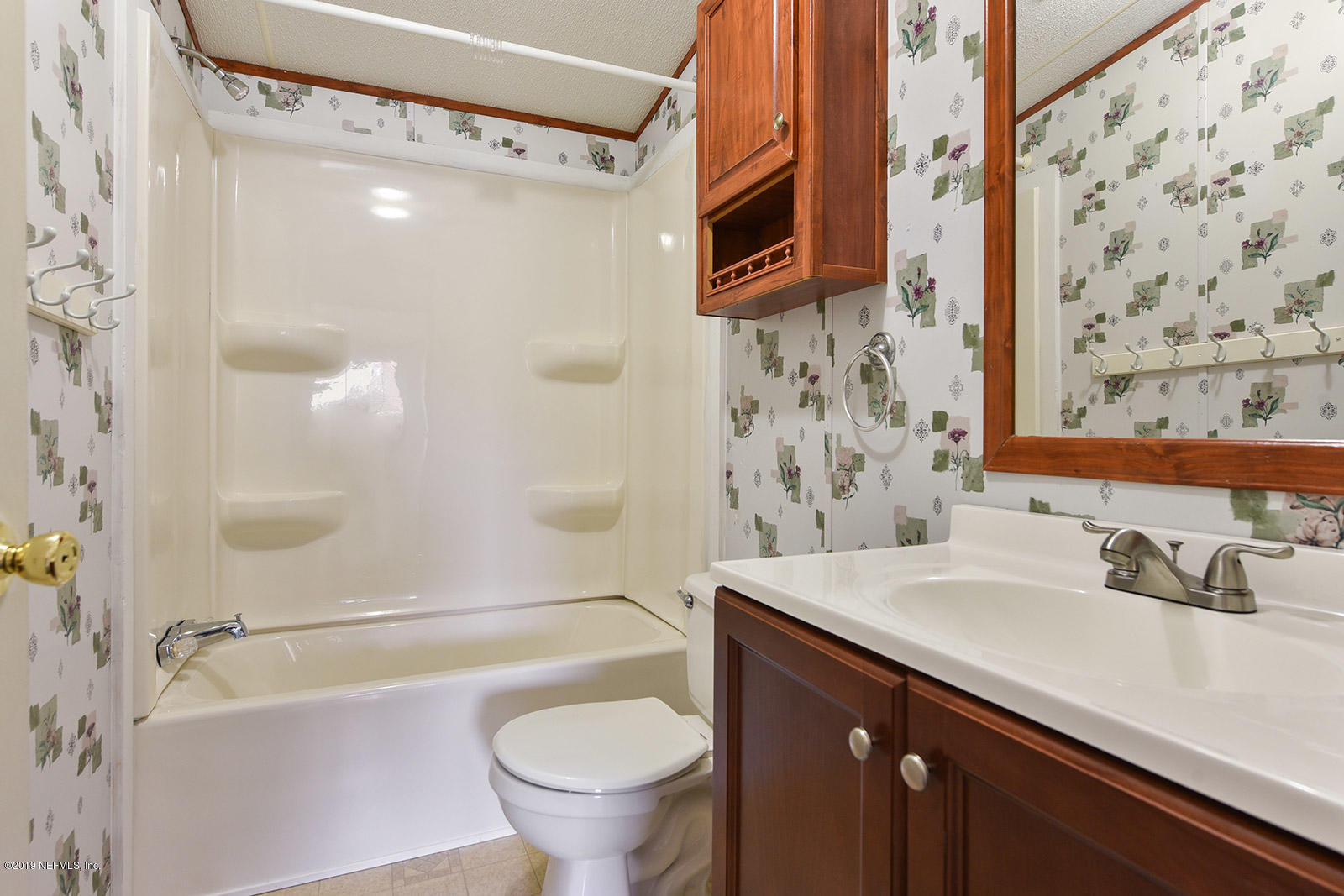 75302 Edwards Road Yulee, FL 32097 - Photo 17 of 25 a bathroom with a sink a toilet and shower curtain