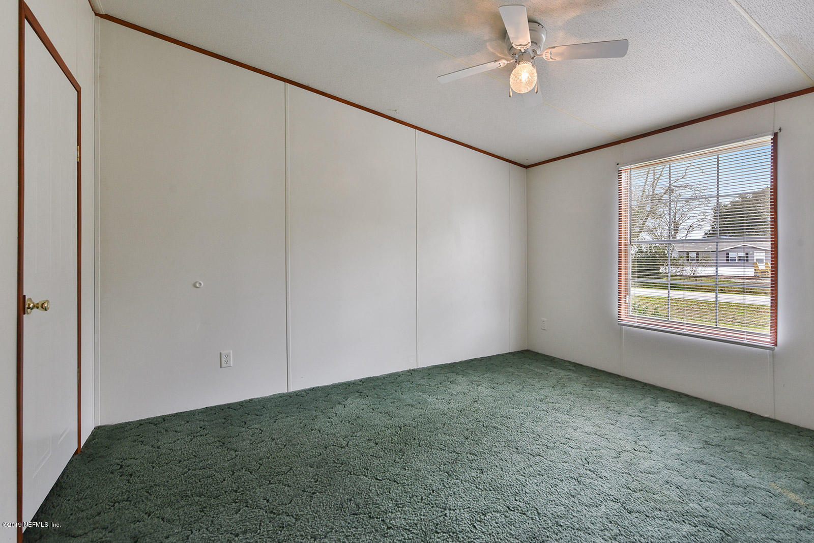 75302 Edwards Road Yulee, FL 32097 - Photo 18 of 25 a view of an empty room with a window