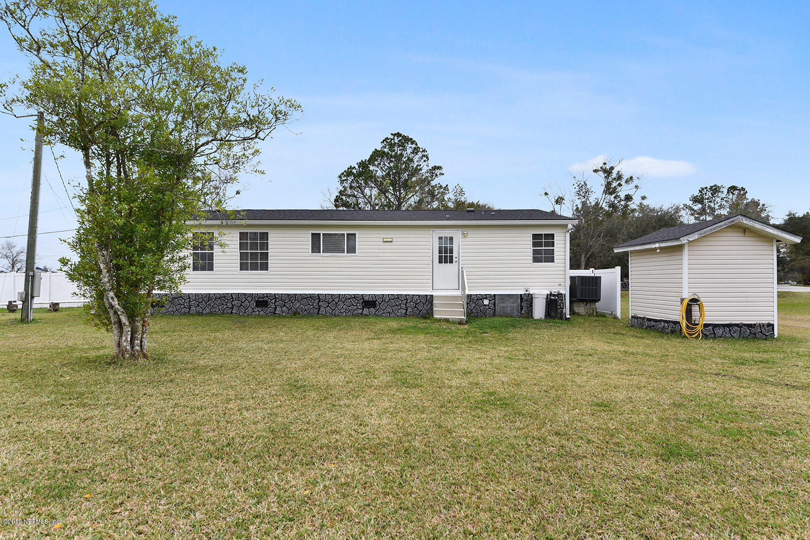 75302 Edwards Road Yulee, FL 32097 - Photo 20 of 25 a view of a house with a backyard