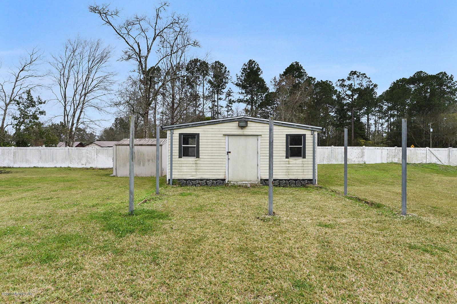 75302 Edwards Road Yulee, FL 32097 - Photo 21 of 25 a backyard of a house with lots of green space