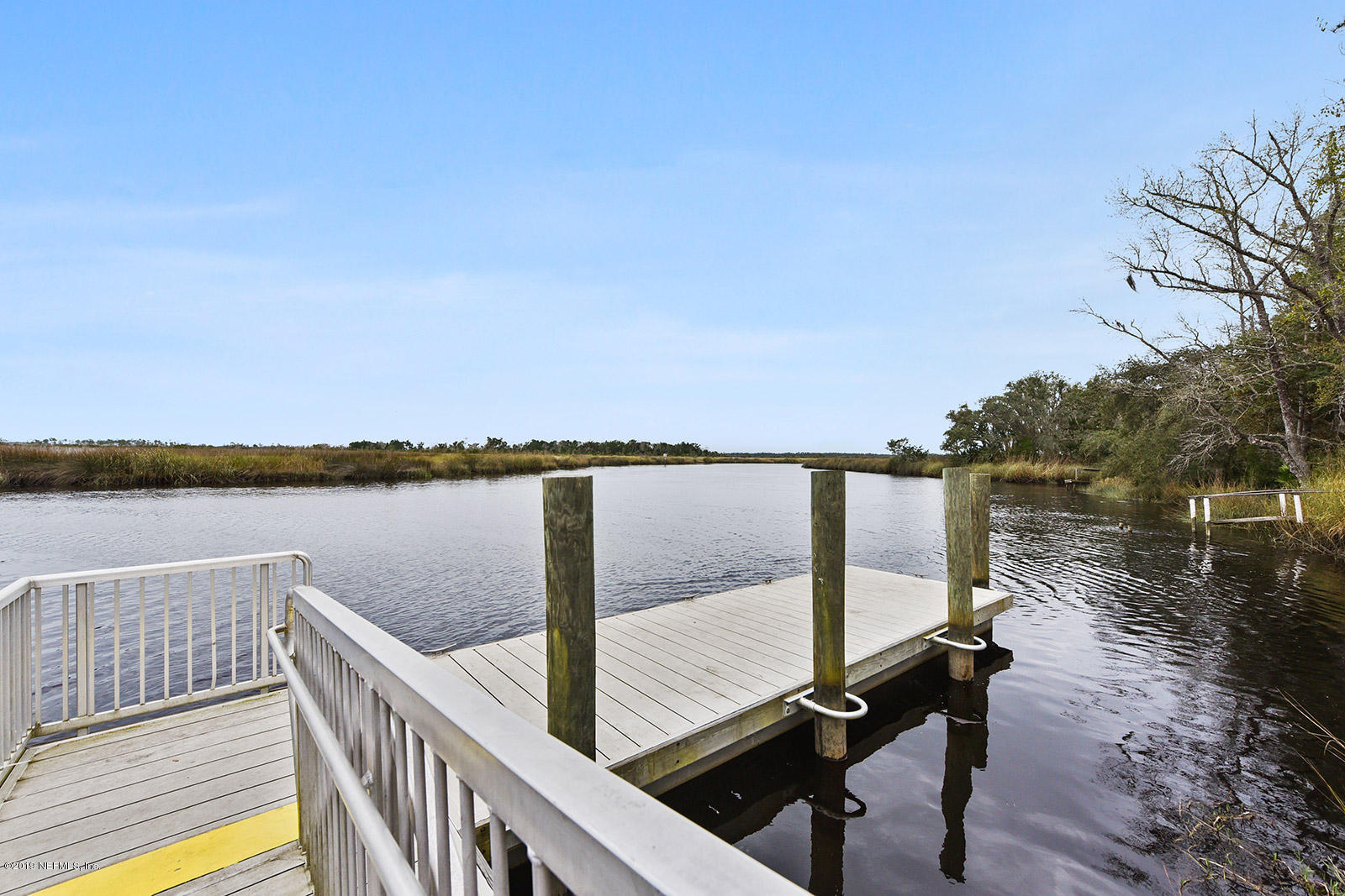 75302 Edwards Road Yulee, FL 32097 - Photo 25 of 25 a view of a balcony with wooden floor and lake view